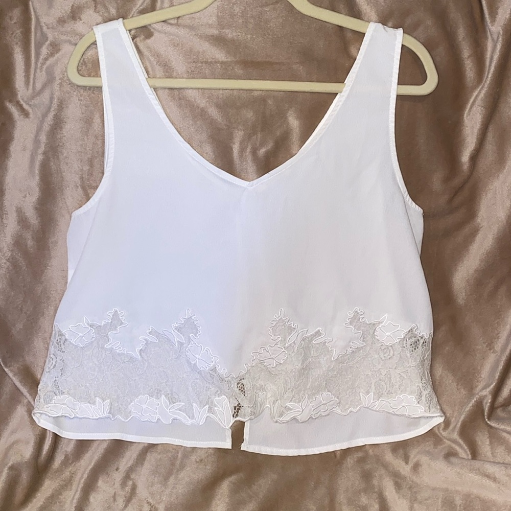 White/ivory blouse with lace design on front